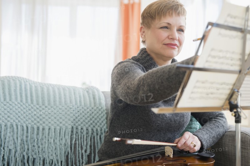 Caucasian violinist writing on sheet music