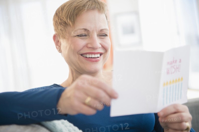 Caucasian woman reading birthday card