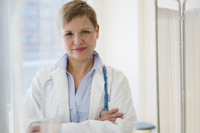 Caucasian doctor standing with arms crossed