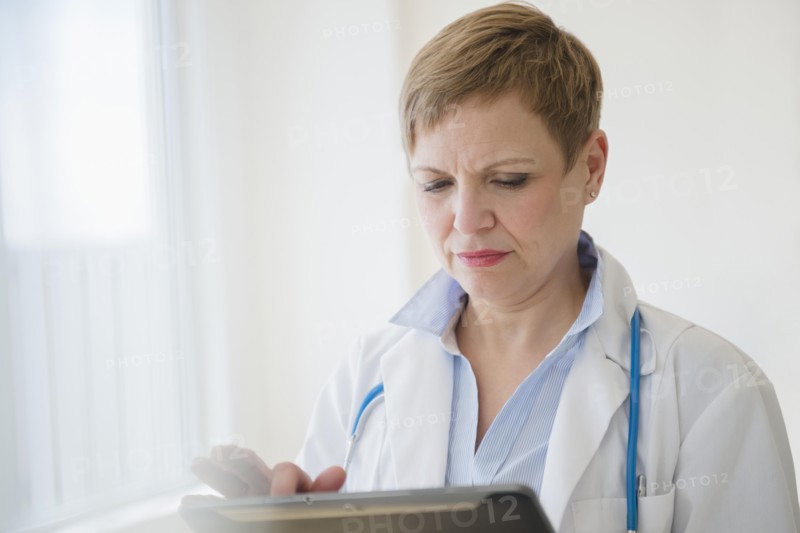 Caucasian doctor using digital tablet