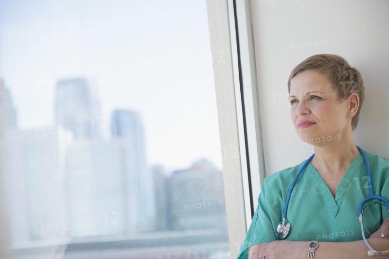 Caucasian nurse near window