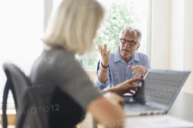 Older Caucasian business people arguing in office meeting