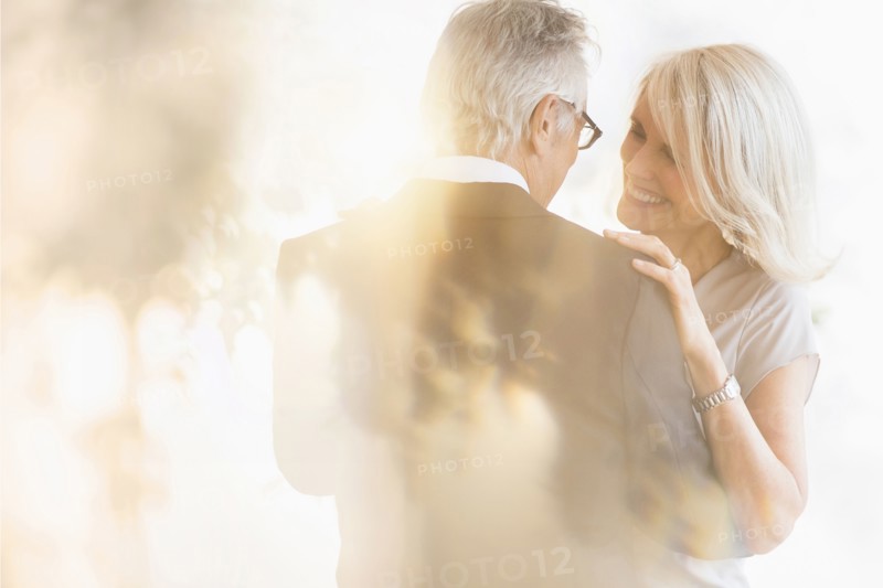 Smiling older Caucasian couple dancing