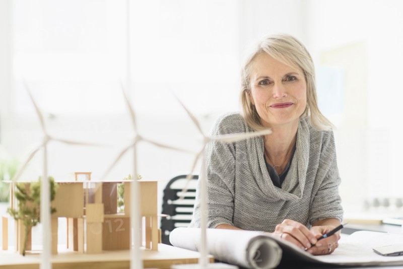 Older Caucasian architect sitting in office