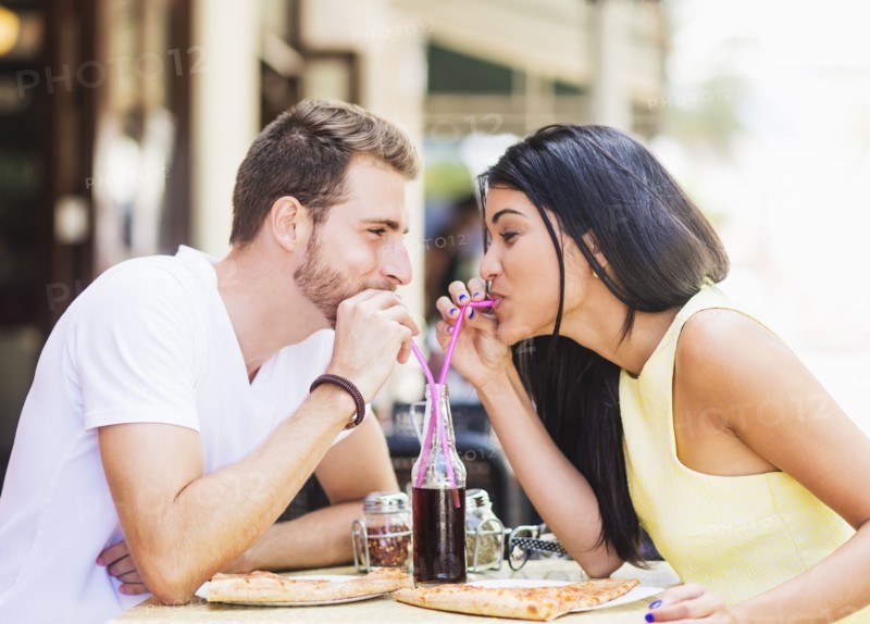 Hispanic couple drinking soda at cafe