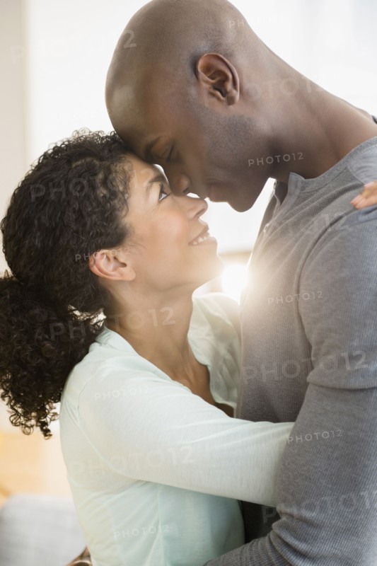 Close up of smiling couple hugging