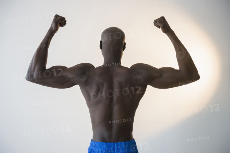 Black man flexing muscles