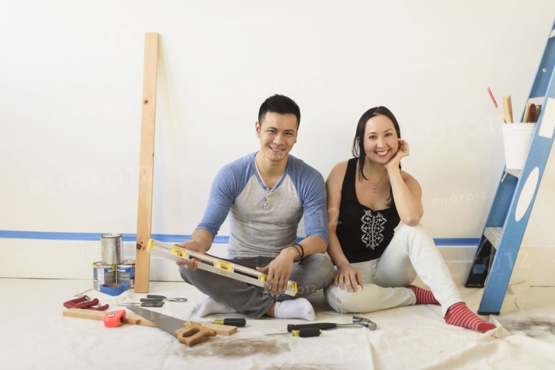Couple sitting on floor during room remodeling