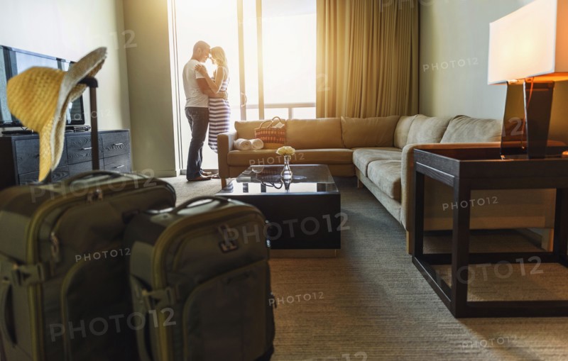 Couple hugging in hotel room