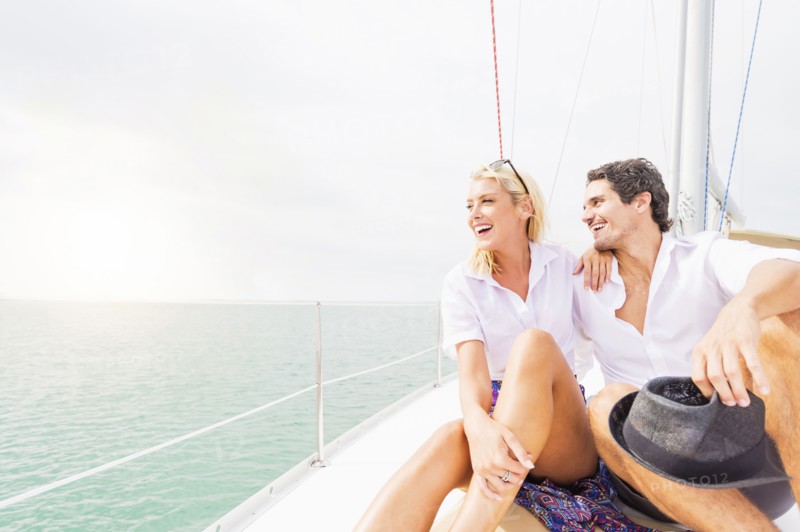 Couple hugging on deck of sailboat