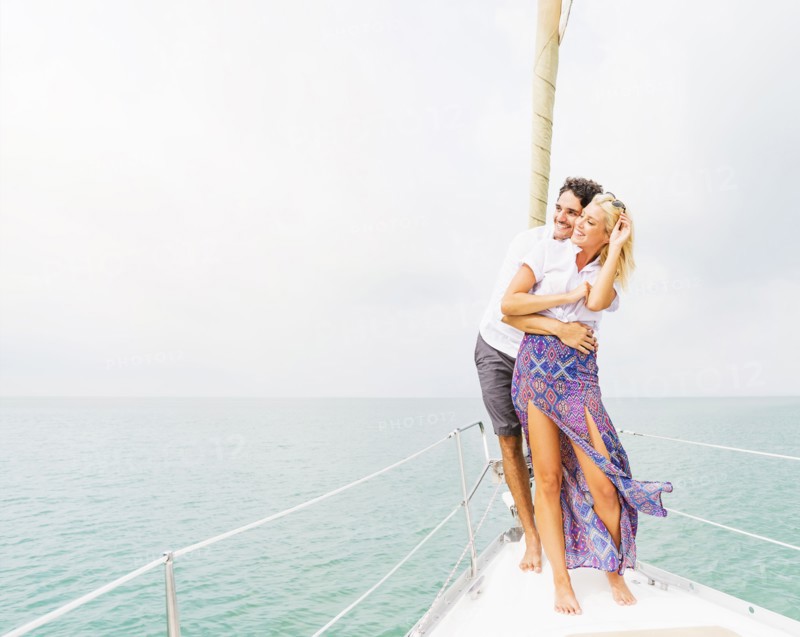 Couple hugging on deck of sailboat