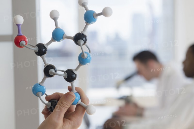 Close up of scientist holding molecular model in lab