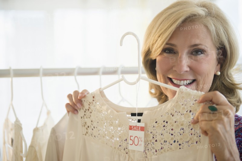 Caucasian woman shopping in clothing store