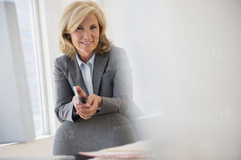 Caucasian businesswoman smiling in office