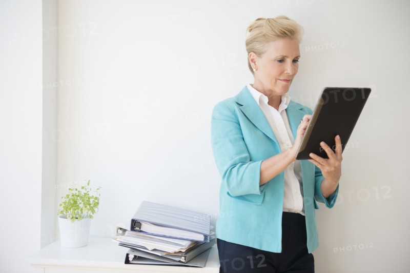 Caucasian businesswoman using digital tablet in office