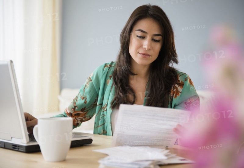 Woman paying bills on laptop