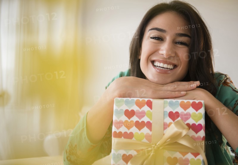 Close up of woman leaning on wrapped gift