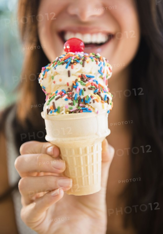 Close up of woman holding ice cream cone