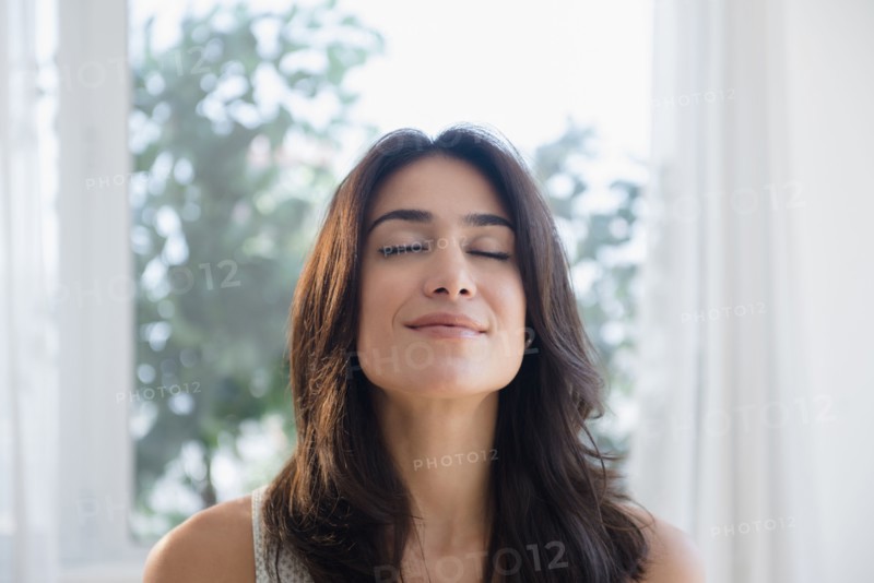 Calm woman breathing with eyes closed