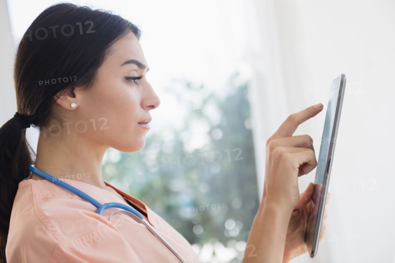 Nurse using digital tablet in hospital