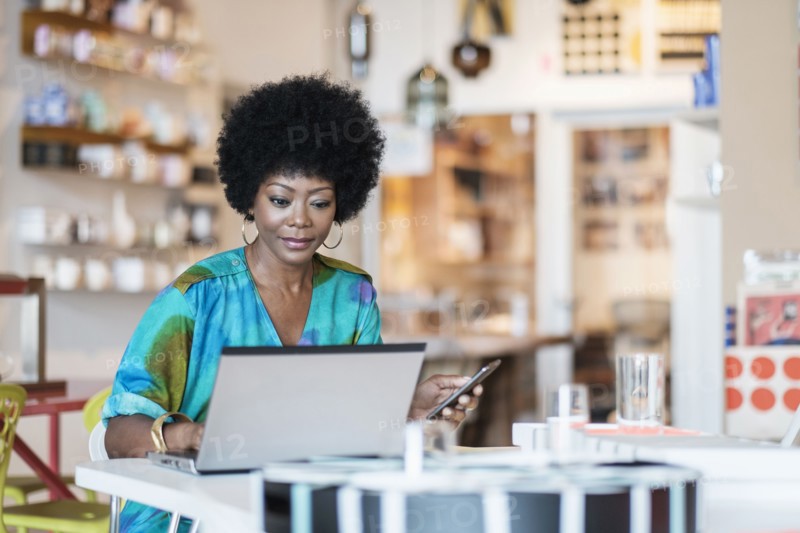 African American business owner using laptop in store