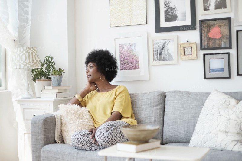 African American woman relaxing on sofa
