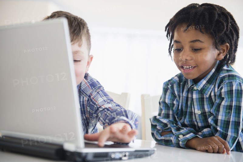 Close up of boys using laptop at desk