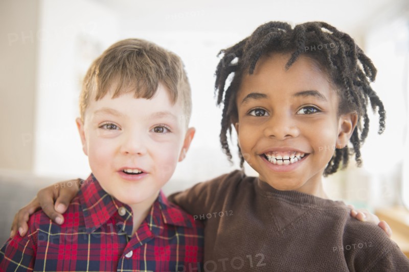 Close up of smiling boys hugging