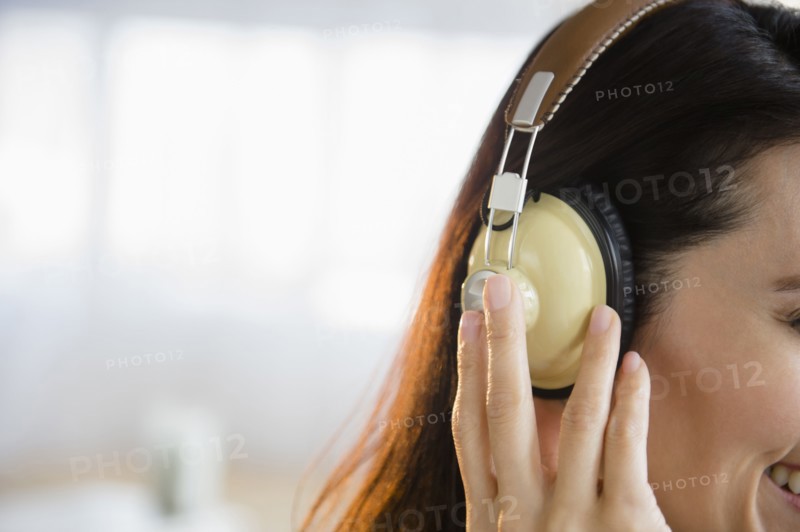 Mixed race woman listening to headphones