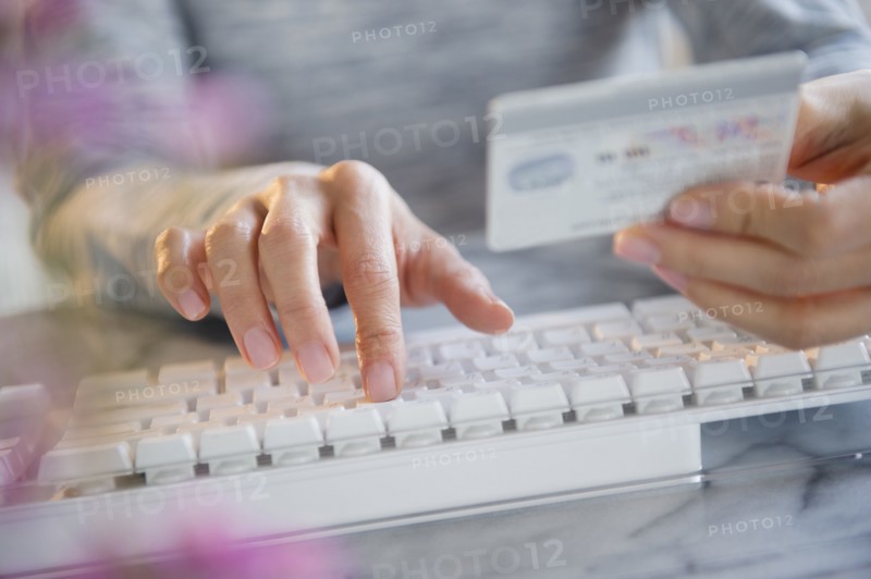 Mixed race woman shopping online with credit card