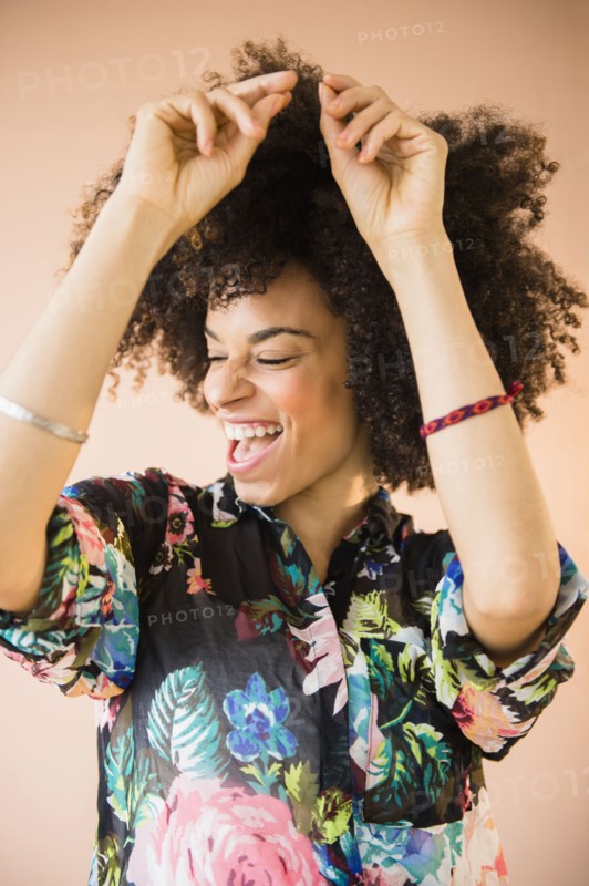Laughing mixed race woman dancing