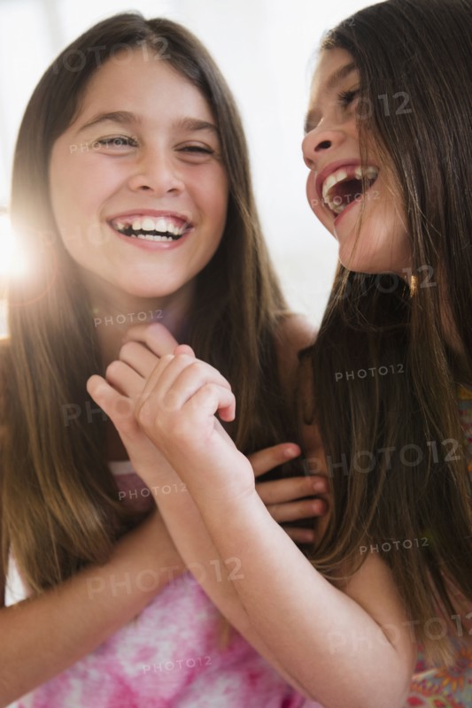 Caucasian twin sisters smiling
