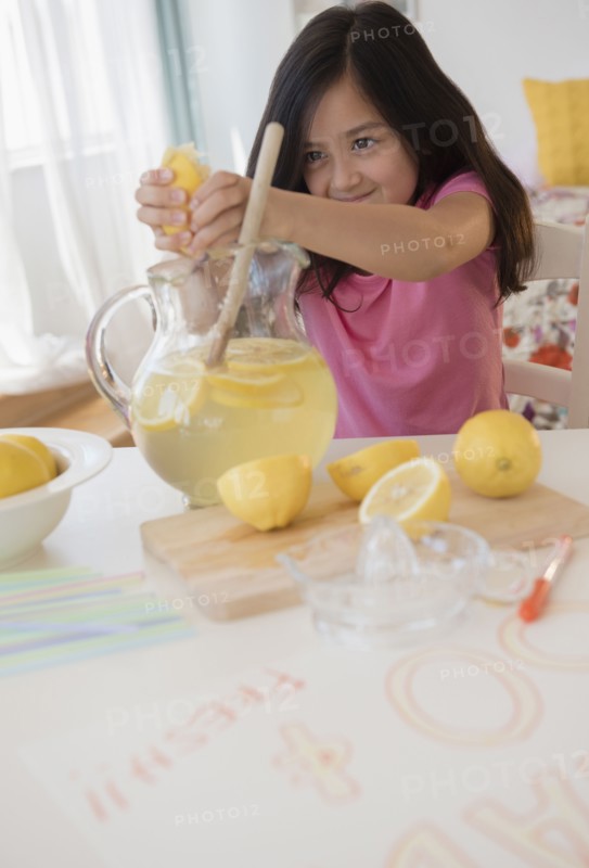 Girl squeezing lemons for lemonade