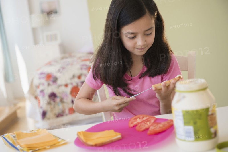 Girl making lunch sandwiches