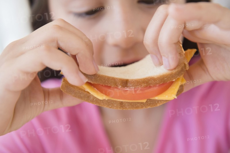 Close up of girl eating sandwich