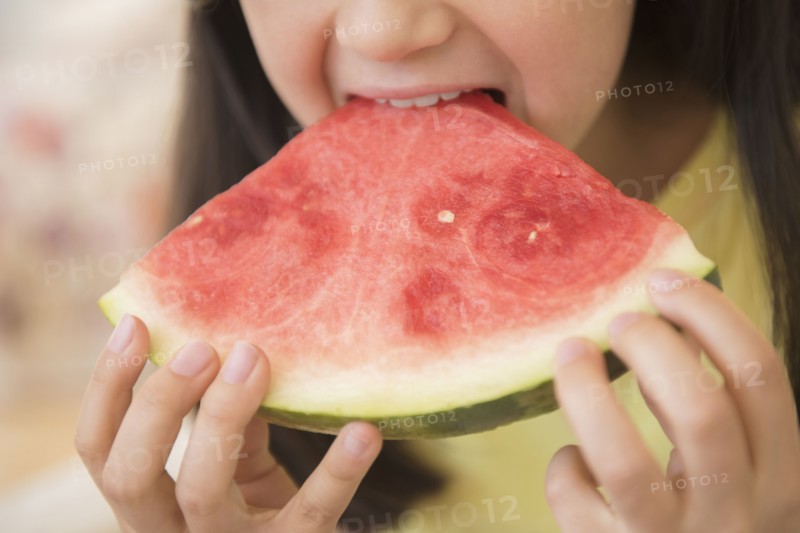Close up of girl eating watermelon