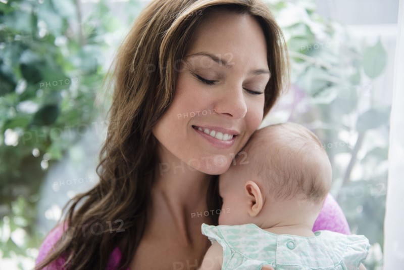 Mother holding baby daughter