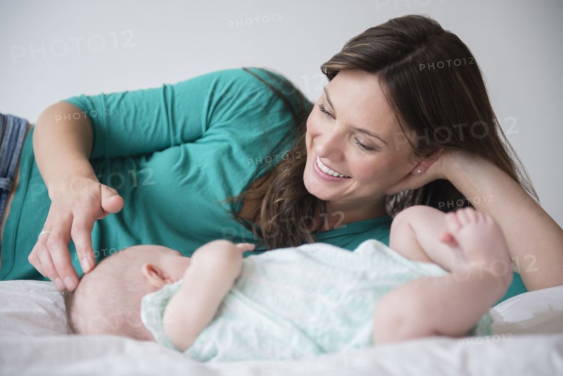 Mother playing with baby daughter