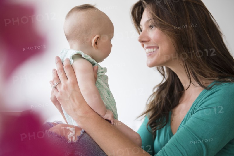 Mother holding baby daughter