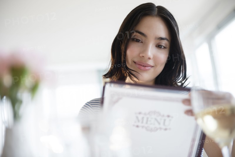 Hispanic woman reading menu