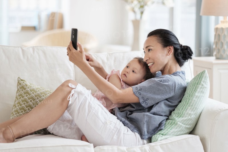 Mother taking selfie with baby daughter