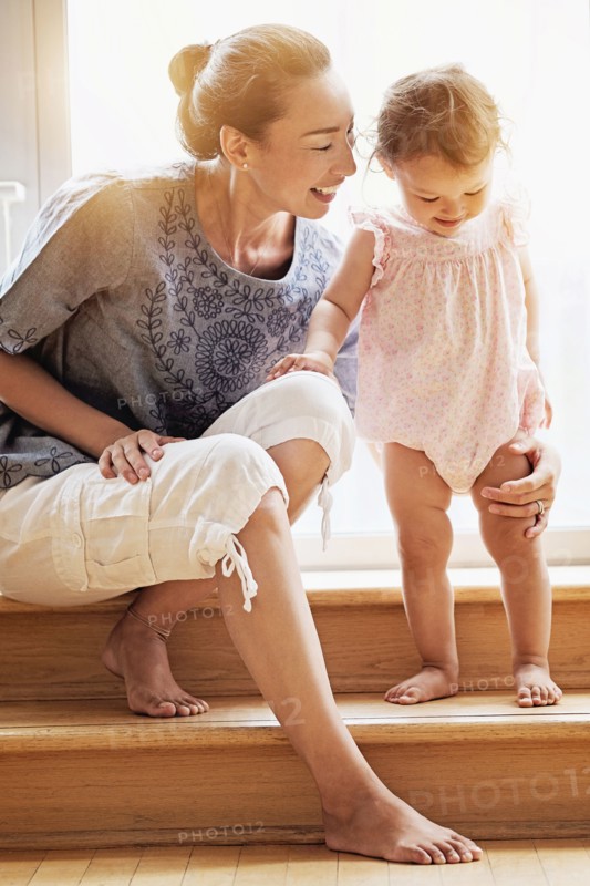 Mother and baby daughter on steps