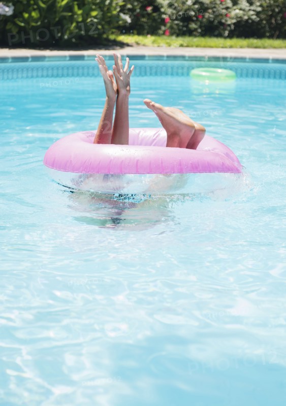 Caucasian woman playing in swimming pool