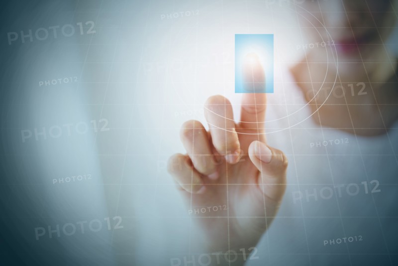 Close up of Hispanic woman touching digital screen