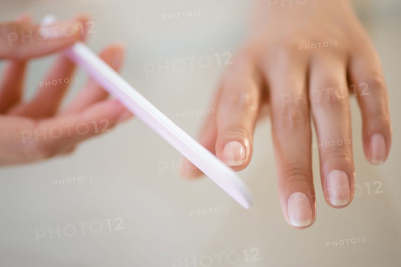 Close up of Hispanic woman filing her nails