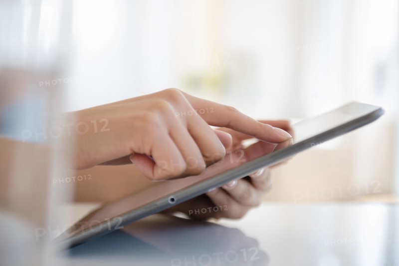 Hispanic woman using digital tablet