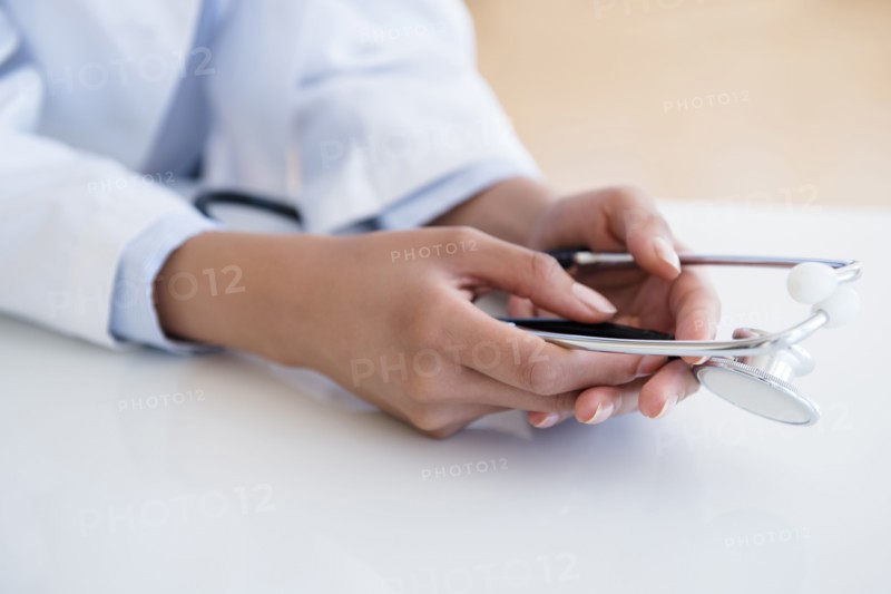 Hispanic doctor holding stethoscope