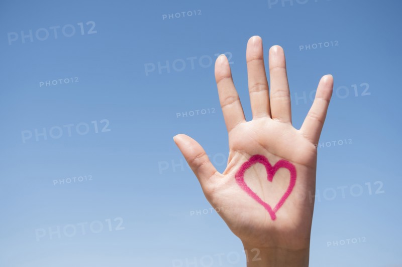 Hispanic woman with heart on hand
