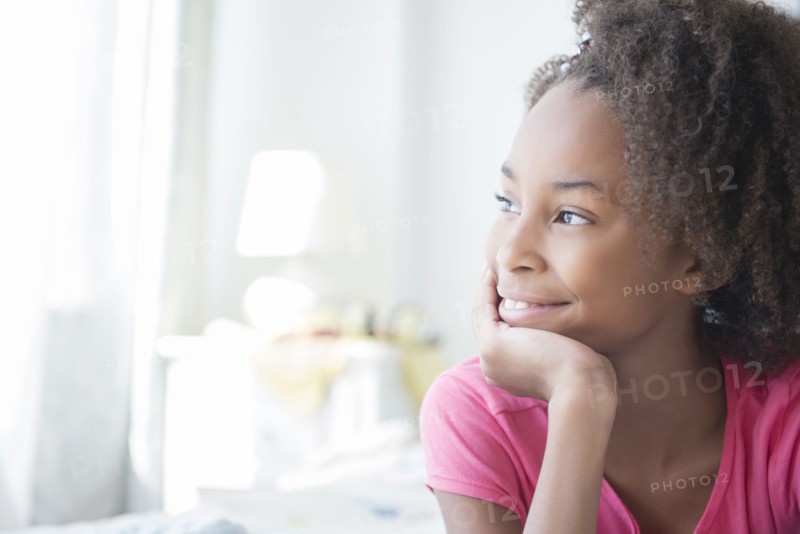Mixed race girl smiling indoors