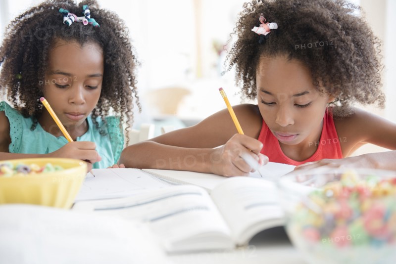 Mixed race sisters doing homework